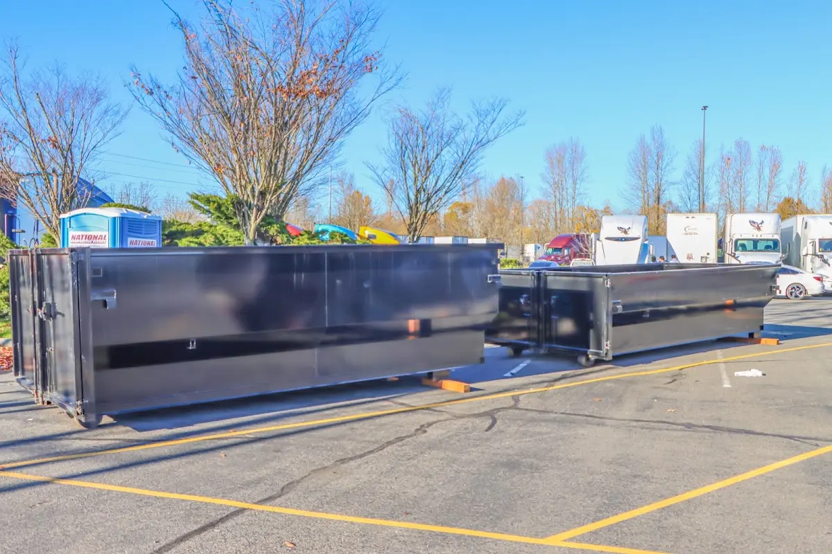 Professional dumpster rental service with roll-off container on residential driveway in Lake Arbor